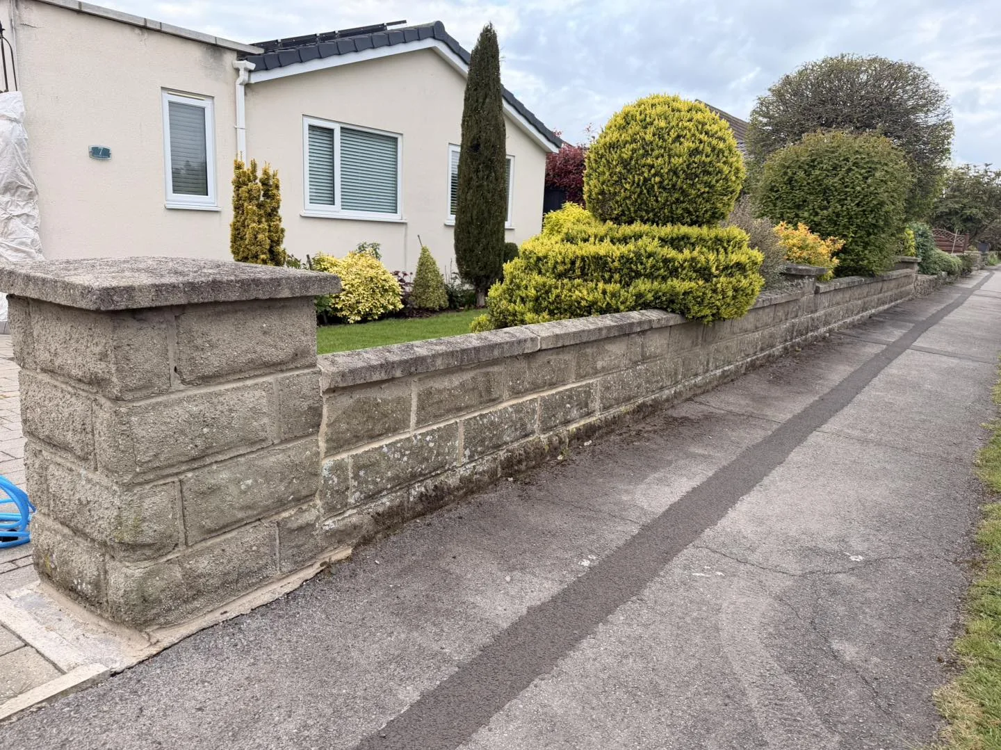 Stone boundary wall clean before cleaning by Hopkins Exterior Cleaning
