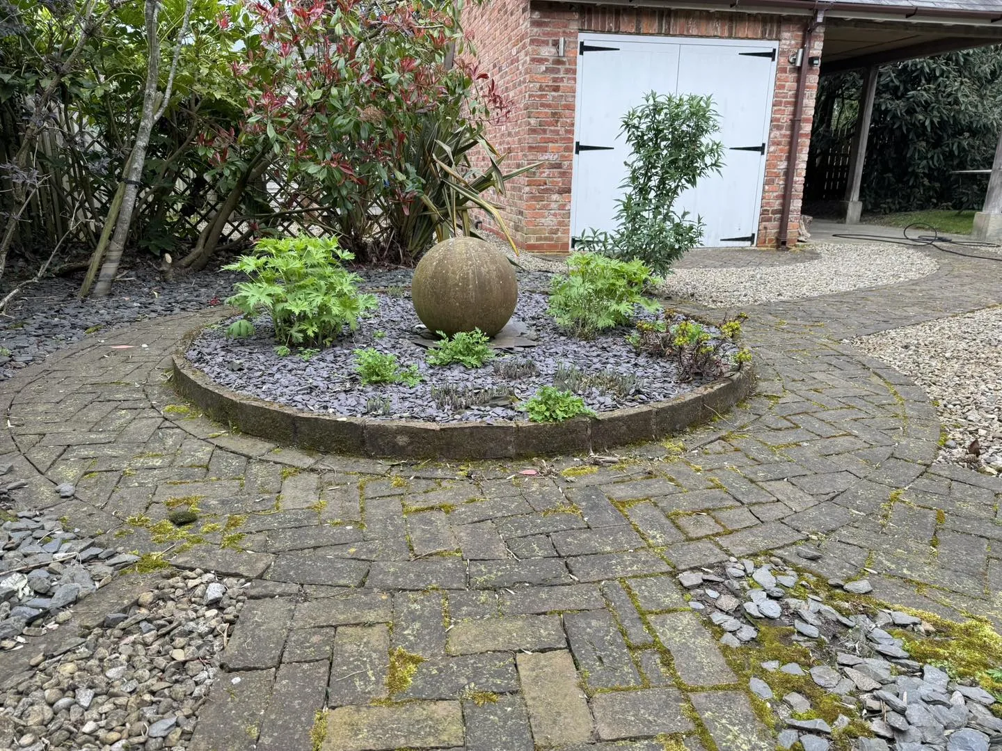 Circular garden patio clean before cleaning by Hopkins Exterior Cleaning